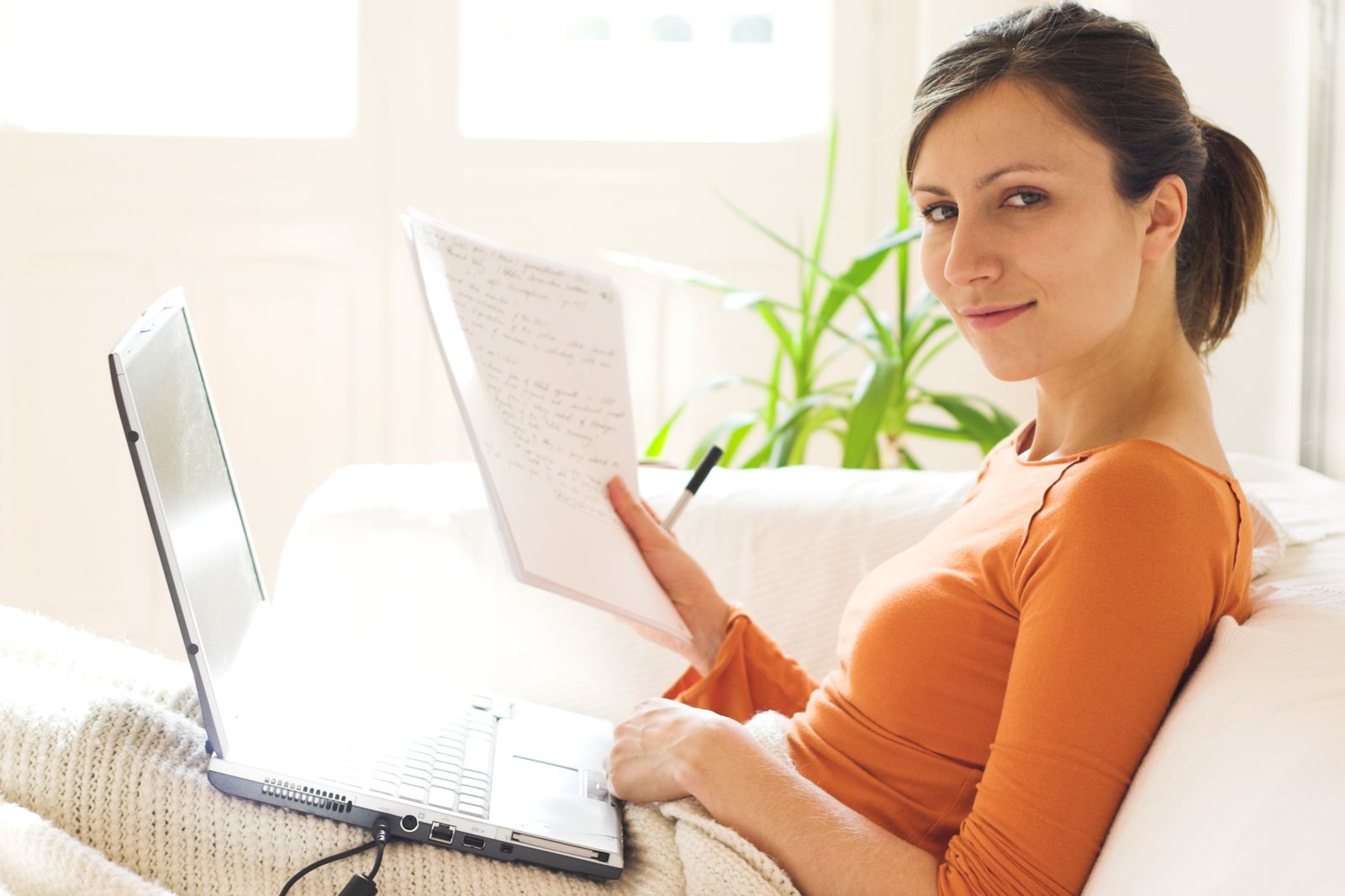 Woman with laptop on couch
